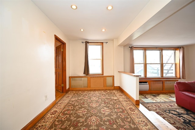 living area featuring baseboards, healthy amount of natural light, recessed lighting, and light wood-style floors