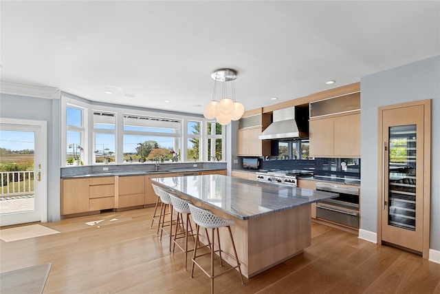 14 S Country Rd, Westhampton, NY 11977 - kitchen with wall chimney range hood, light brown cabinetry, modern cabinets, wine cooler, and recessed lighting