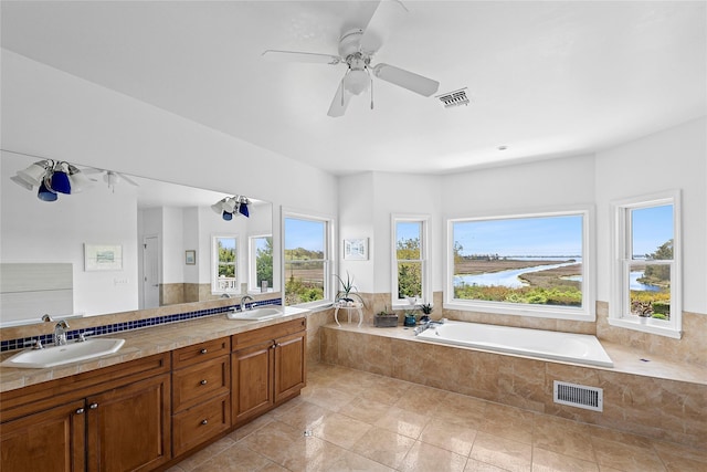 14 S Country Rd, Westhampton, NY 11977 - full bath featuring plenty of natural light, double vanity, a garden tub, and tile patterned flooring