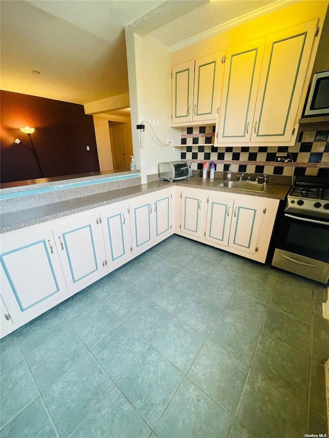 102-21 63rd Rd Unit 47A, Forest Hills, NY 11375 - kitchen featuring appliances with stainless steel finishes, a sink, decorative backsplash, and dark tile patterned floors