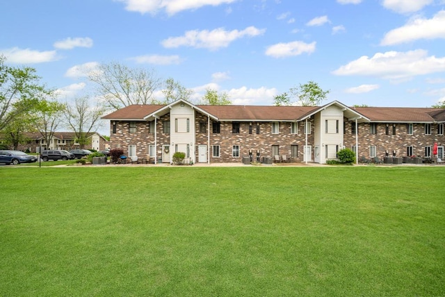 9 Sierra Ct Unit 0, Coram, NY 11727 - view of front facade with a front lawn, brick siding, and central AC