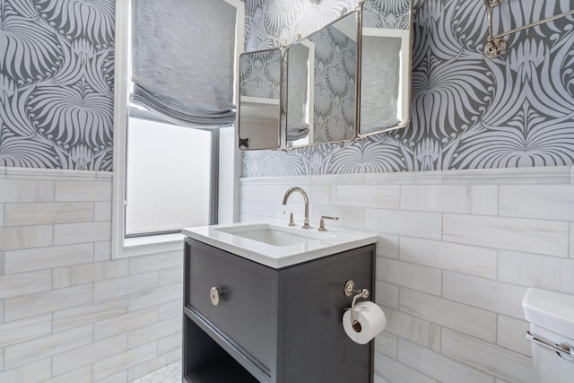 89-10 35th Ave Unit F2L, Jackson Heights, NY 11372 - bathroom with wallpapered walls, wainscoting, vanity, and tile walls