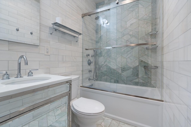 89-10 35th Ave Unit F2L, Jackson Heights, NY 11372 - bathroom featuring shower / bath combination with glass door, toilet, vanity, tile walls, and backsplash
