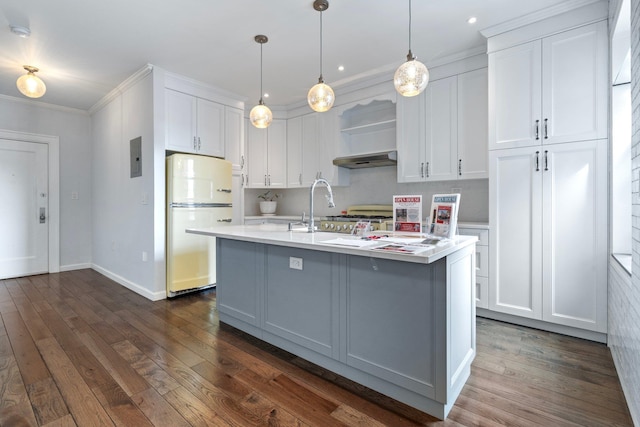 89-10 35th Ave Unit F2L, Jackson Heights, NY 11372 - kitchen with freestanding refrigerator, light countertops, white cabinets, dark wood finished floors, and crown molding