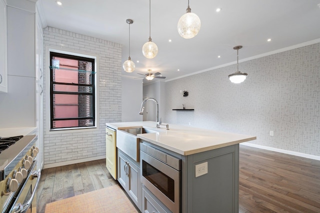 89-10 35th Ave Unit F2L, Jackson Heights, NY 11372 - kitchen with gray cabinets, a sink, dark wood-type flooring, stainless steel appliances, and crown molding