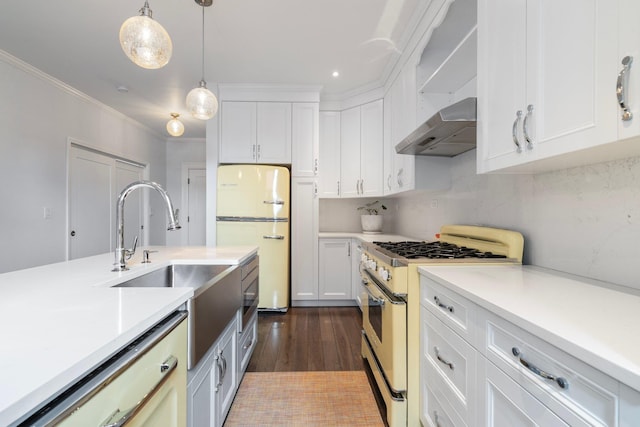 89-10 35th Ave Unit F2L, Jackson Heights, NY 11372 - kitchen featuring range with gas stovetop, freestanding refrigerator, wall chimney range hood, light countertops, and white cabinetry