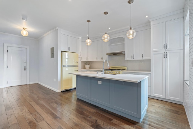89-10 35th Ave Unit F2L, Jackson Heights, NY 11372 - kitchen with freestanding refrigerator, light countertops, white cabinets, dark wood-style floors, and crown molding