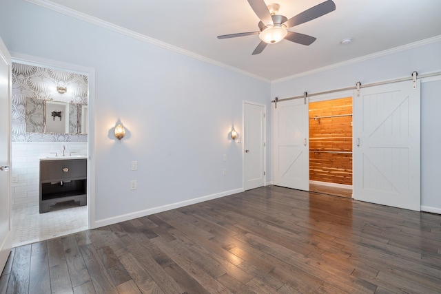 89-10 35th Ave Unit F2L, Jackson Heights, NY 11372 - unfurnished bedroom with a barn door, hardwood / wood-style flooring, ornamental molding, a sink, and baseboards