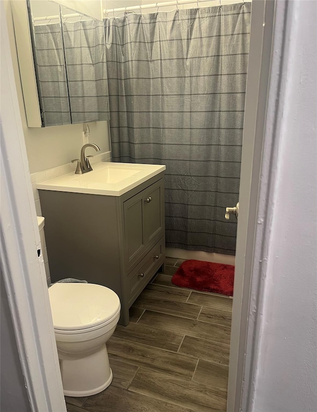 5 Adelaide St Unit B2, A1, Floral Park, NY 11001 - bathroom with wood finish floors, vanity, and toilet