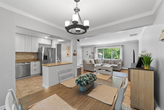 10 Ridge Rd, Cortlandt Manor, NY 10567 - dining space with a chandelier and crown molding