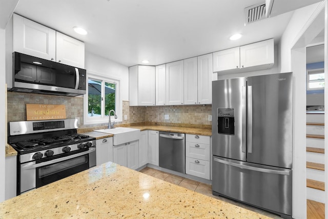 10 Ridge Rd, Cortlandt Manor, NY 10567 - kitchen featuring appliances with stainless steel finishes, a sink, healthy amount of natural light, white cabinetry, and recessed lighting