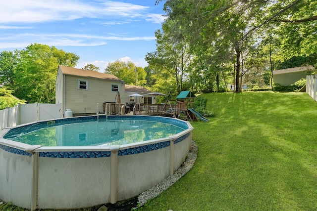 10 Ridge Rd, Cortlandt Manor, NY 10567 - view of swimming pool featuring a wooden deck, a playground, and view of scattered trees