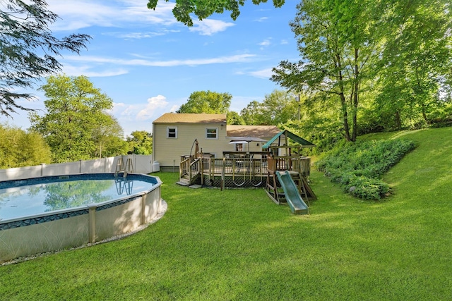 10 Ridge Rd, Cortlandt Manor, NY 10567 - rear view of house with a yard, a playground, and a wooden deck
