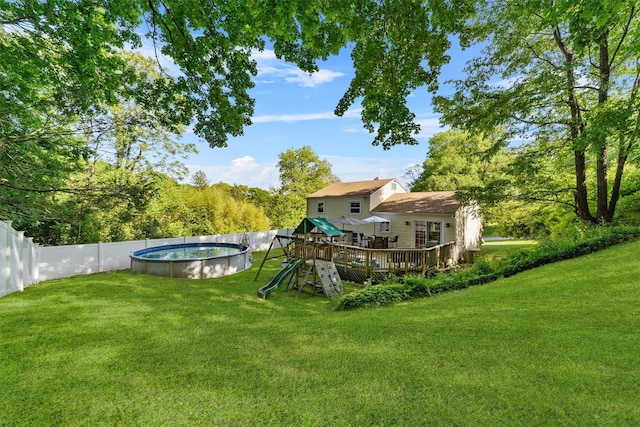 10 Ridge Rd, Cortlandt Manor, NY 10567 - rear view of house with a wooden deck and a playground