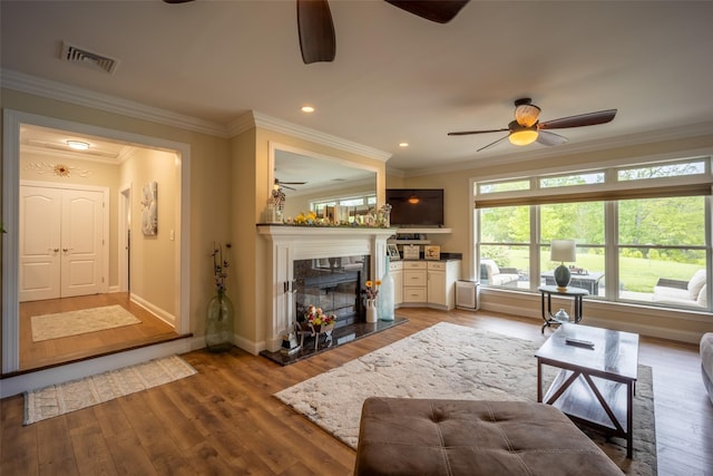 62 Freedom Rd, Pleasant Valley, NY 12569 - living area featuring ceiling fan, a fireplace, wood finished floors, baseboards, and ornamental molding
