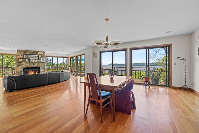 1260 Albany Post Rd, Croton-On-Hudson, NY 10520 - dining space featuring light wood-type flooring, a fireplace, a chandelier, and recessed lighting