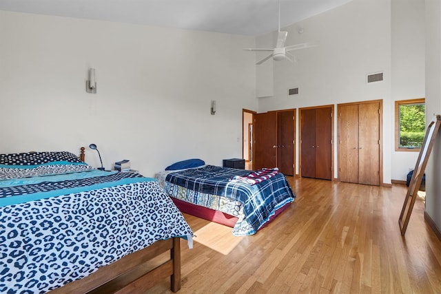 1260 Albany Post Rd, Croton-On-Hudson, NY 10520 - bedroom with high vaulted ceiling, light wood finished floors, multiple closets, and a ceiling fan
