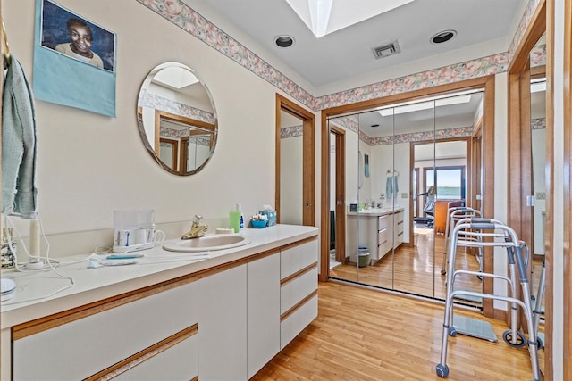 1260 Albany Post Rd, Croton-On-Hudson, NY 10520 - bathroom featuring vanity, wood finished floors, and a skylight