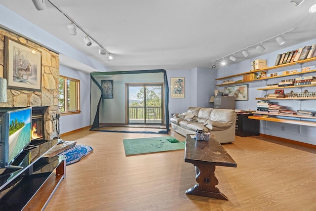 1260 Albany Post Rd, Croton-On-Hudson, NY 10520 - living area with rail lighting, wood finished floors, a fireplace, and healthy amount of natural light