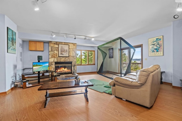 1260 Albany Post Rd, Croton-On-Hudson, NY 10520 - living area with track lighting, wood finished floors, and a fireplace