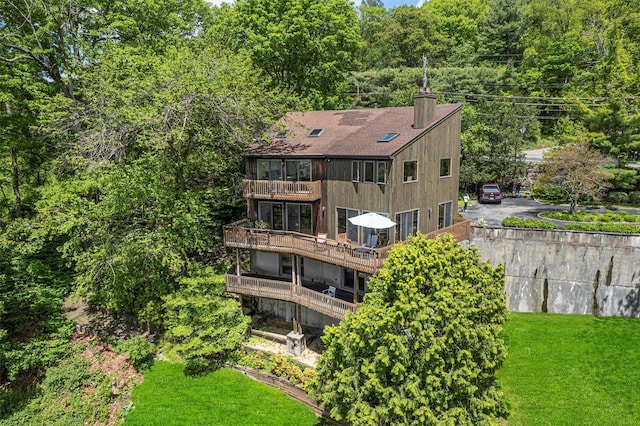 1260 Albany Post Rd, Croton-On-Hudson, NY 10520 - back of property with a balcony, a chimney, a yard, and a shingled roof