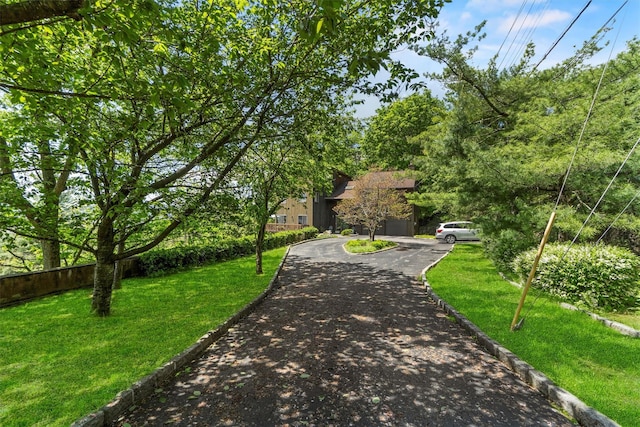 1260 Albany Post Rd, Croton-On-Hudson, NY 10520 - view of front of property with asphalt driveway, a front lawn, and an attached garage