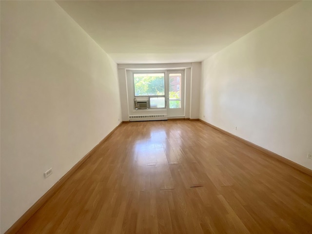 98-05 63rd Rd Unit 1C, Rego Park, NY 11374 - unfurnished room with light wood finished floors, baseboards, and cooling unit