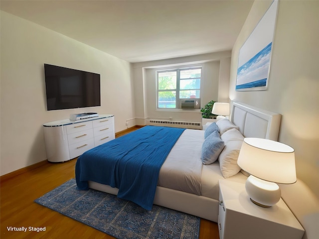 98-05 63rd Rd Unit 1C, Rego Park, NY 11374 - bedroom with a baseboard radiator, wood finished floors, cooling unit, and baseboards