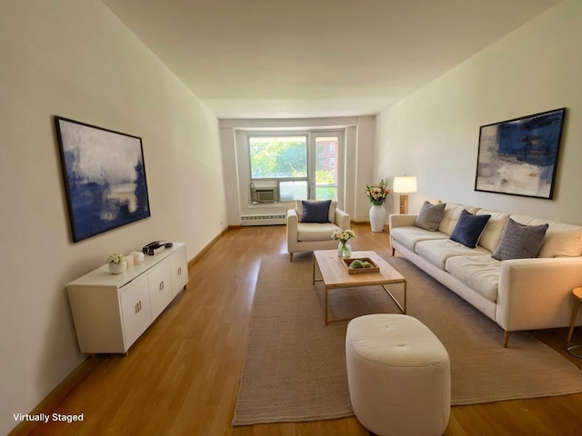 98-05 63rd Rd Unit 1C, Rego Park, NY 11374 - living area featuring light wood finished floors, cooling unit, and baseboards