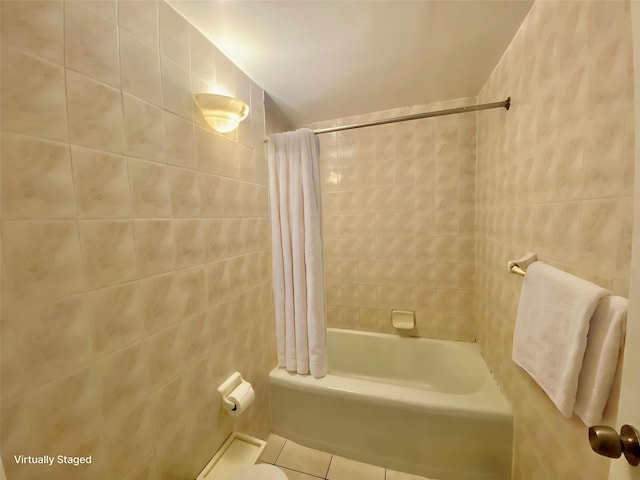 98-05 63rd Rd Unit 1C, Rego Park, NY 11374 - bathroom with tile patterned floors, tile walls, and shower / bathtub combination with curtain