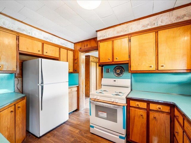 58 Hathorn Blvd, Port Jervis, NY 12771 - kitchen featuring white appliances, dark wood-style floors, and brown cabinetry