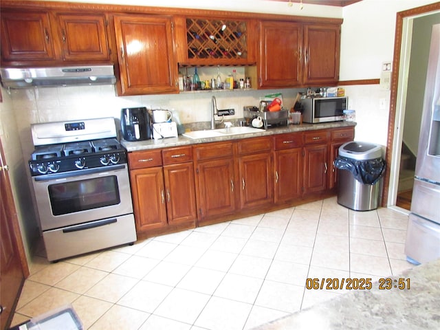 1 Cheshire Ln, Yonkers, NY 10710 - kitchen with appliances with stainless steel finishes, under cabinet range hood, backsplash, brown cabinetry, and light countertops