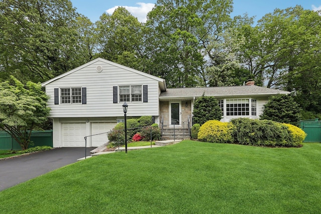 56 Rolling Way, New Rochelle, NY 10804 - tri-level home with a garage, asphalt driveway, and a chimney