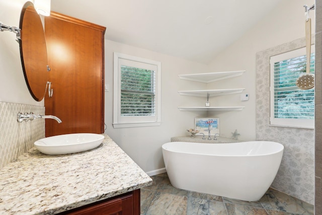 56 Rolling Way, New Rochelle, NY 10804 - full bathroom featuring vanity, healthy amount of natural light, a soaking tub, lofted ceiling, and baseboards