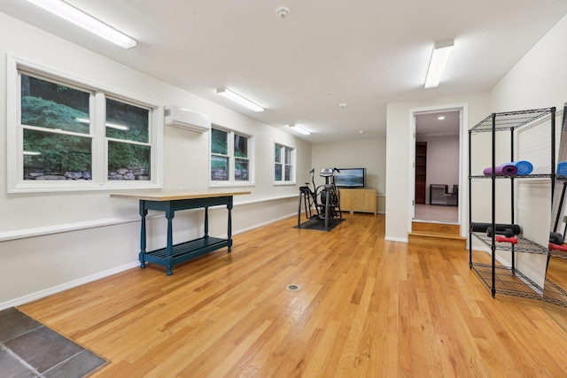 56 Rolling Way, New Rochelle, NY 10804 - workout room featuring wood finished floors, an AC wall unit, and baseboards