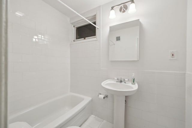 56 Rolling Way, New Rochelle, NY 10804 - bathroom with tile walls and bathing tub / shower combination