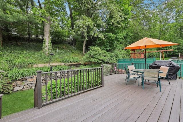 56 Rolling Way, New Rochelle, NY 10804 - wooden terrace with outdoor dining space, view of wooded area, and a pool