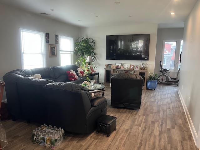 living area featuring wood finished floors and baseboards