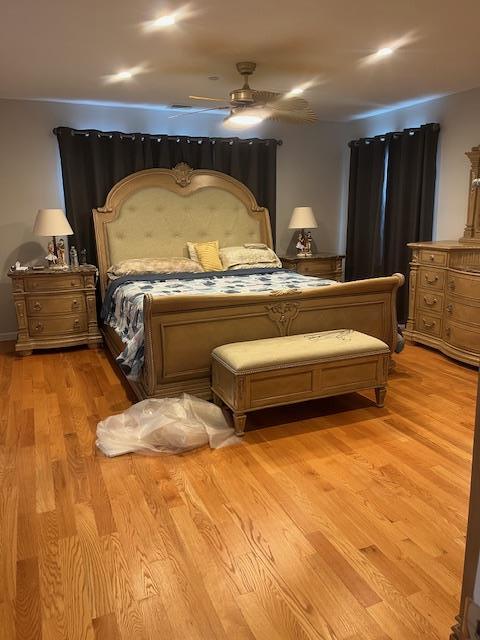 bedroom with light wood finished floors and ceiling fan