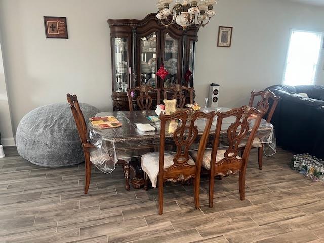 dining room with a chandelier and wood finished floors