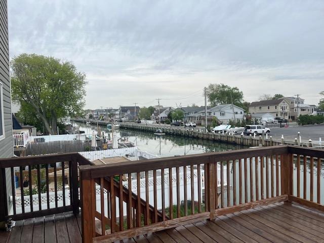 deck featuring a water view and a residential view