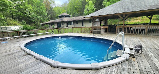 view of pool featuring a deck and a gazebo