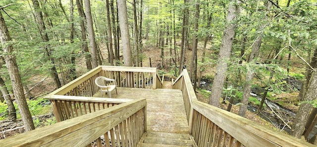 wooden terrace with a wooded view