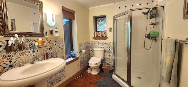 full bath with a shower stall, wood finished floors, tile walls, toilet, and a wainscoted wall