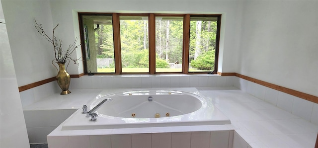 full bathroom with plenty of natural light and a jetted tub