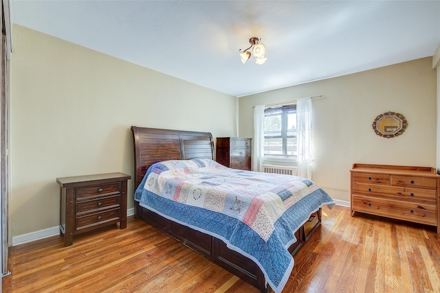 bedroom featuring wood finished floors and baseboards