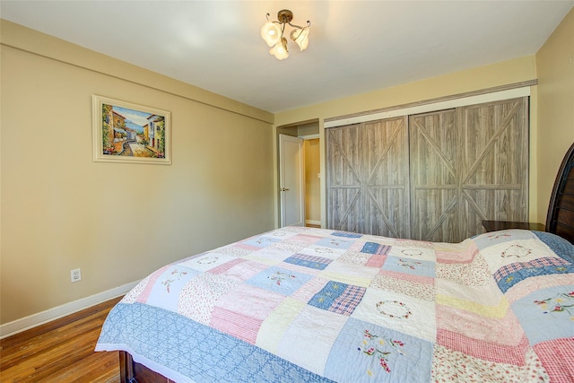 bedroom with wood finished floors and baseboards
