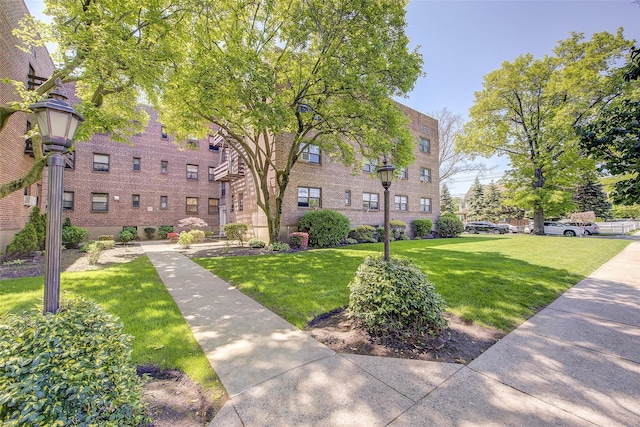 view of property's community with a lawn