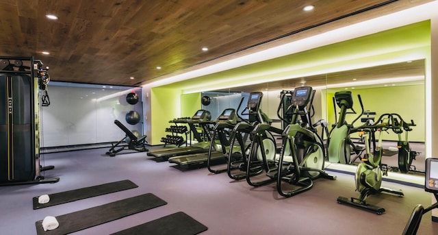 exercise room featuring wood ceiling and recessed lighting