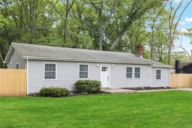 view of front of home with a chimney and a shingled roof
